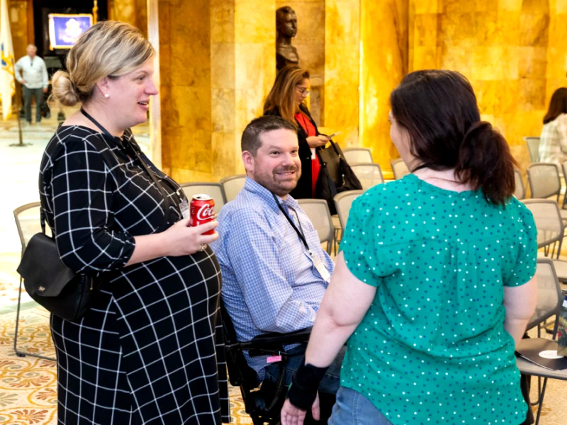 Chuck and Nicole talking with a fellow ALS patient at the ALS Advocacy Day event